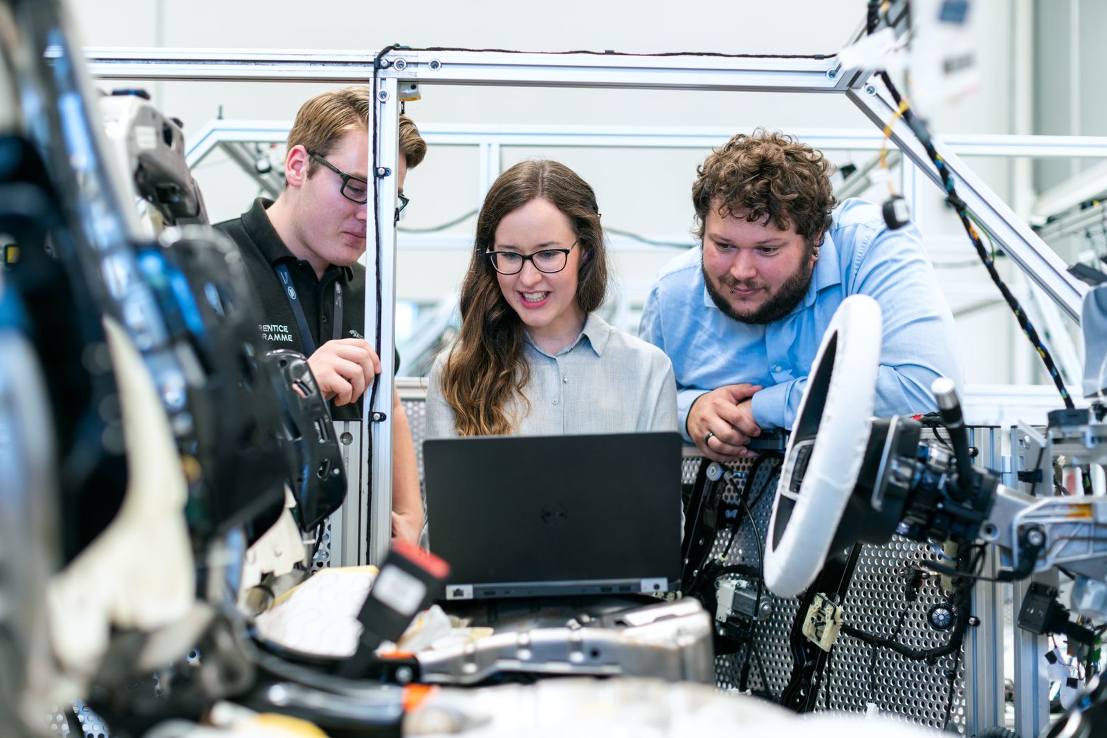 Engineers reviewing technical systems together in a modern workshop