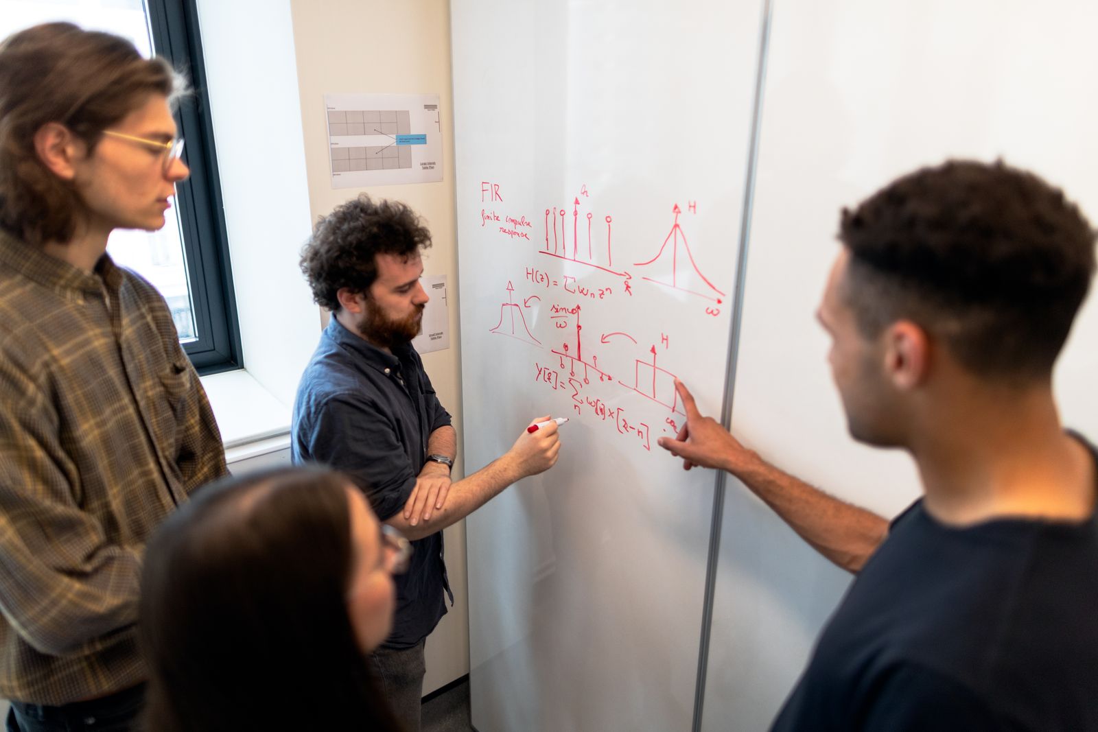 Technical team discussing engineering analysis during a workshop